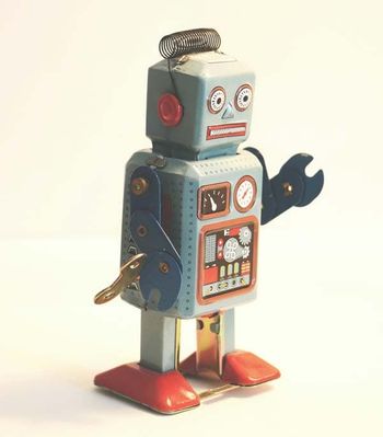 A rustic robot standing on a white background.